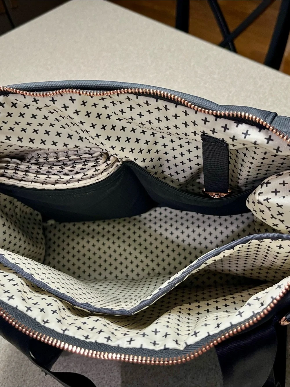 Petunia Pickle Bottom Cream and Black Cross-Print Bag with Rose Gold Hardware